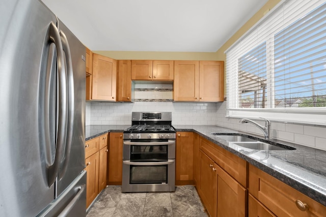 2720 S Christiana Ave, Chicago, IL 60623 - kitchen featuring decorative backsplash, dark stone counters, appliances with stainless steel finishes, and a sink