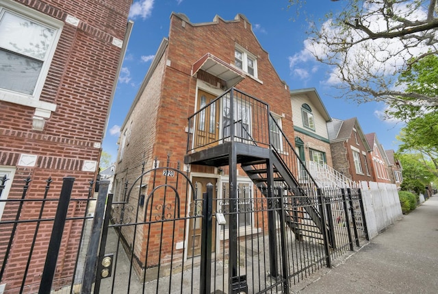 2720 S Christiana Ave, Chicago, IL 60623 - exterior space featuring a fenced front yard, stairs, a gate, and brick siding
