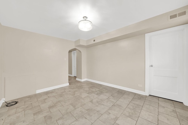 2720 S Christiana Ave, Chicago, IL 60623 - unfurnished room featuring arched walkways, baseboards, and visible vents