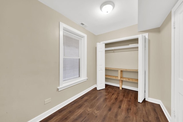 2720 S Christiana Ave, Chicago, IL 60623 - unfurnished bedroom with a closet, visible vents, baseboards, and dark wood-style floors
