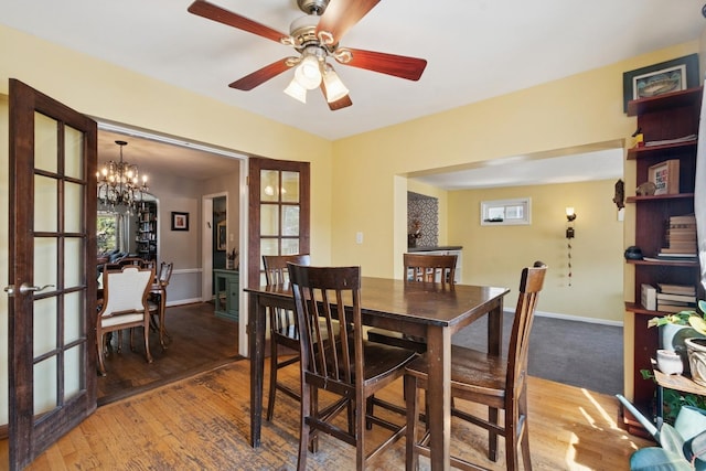 2815 W Jarvis Ave, Chicago, IL 60645 - dining area featuring light wood-style flooring, a ceiling fan, baseboards, a chandelier, and french doors
