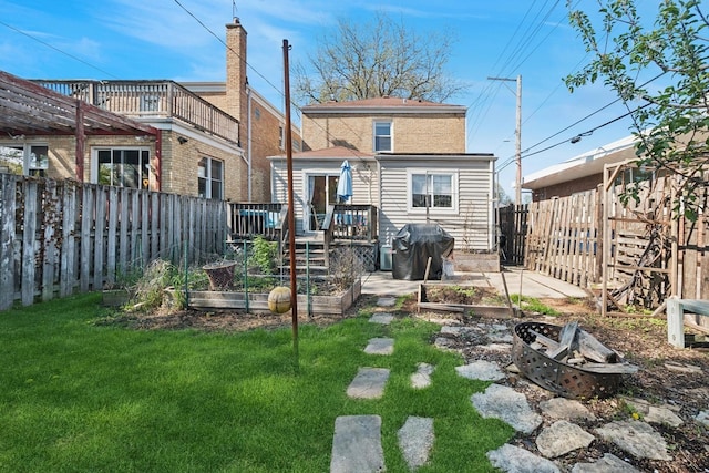 2815 W Jarvis Ave, Chicago, IL 60645 - rear view of property with a garden, a deck, and a fire pit