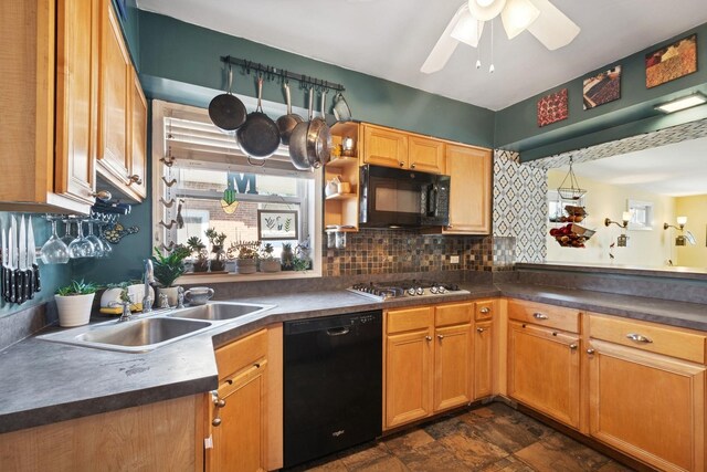 2815 W Jarvis Ave, Chicago, IL 60645 - kitchen with black appliances, a sink, a ceiling fan, dark countertops, and backsplash
