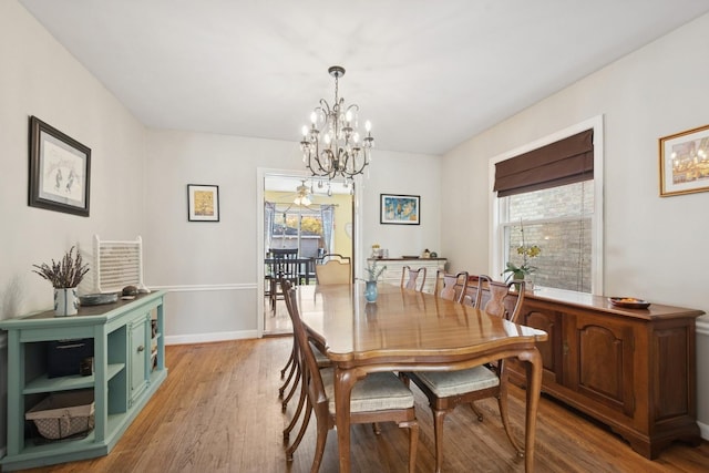 2815 W Jarvis Ave, Chicago, IL 60645 - dining room featuring plenty of natural light, light wood finished floors, and a chandelier