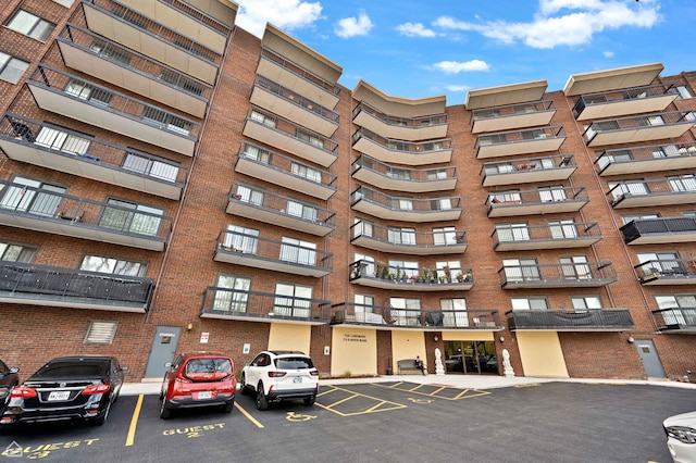 711 S River Rd S Unit 309, Des Plaines, IL 60016 - view of apartment building / complex featuring uncovered parking