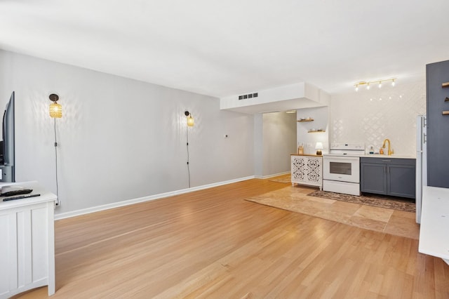 260 E Chestnut St Unit 1706, Chicago, IL 60611 - unfurnished living room with light wood finished floors and track lighting