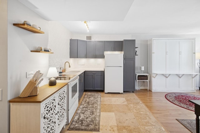 260 E Chestnut St Unit 1706, Chicago, IL 60611 - kitchen with white appliances, open shelves, a sink, gray cabinets, and decorative backsplash