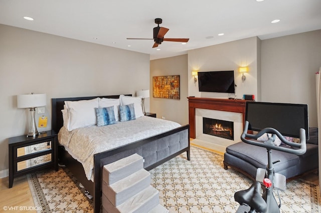 1442 W Cuyler Ave, Chicago, IL 60613 - bedroom featuring a lit fireplace, light wood-style flooring, a ceiling fan, and recessed lighting