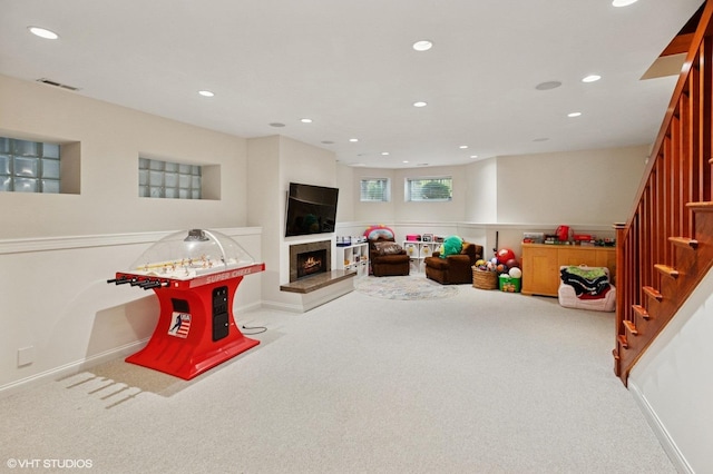 1442 W Cuyler Ave, Chicago, IL 60613 - playroom with carpet, a lit fireplace, visible vents, baseboards, and recessed lighting