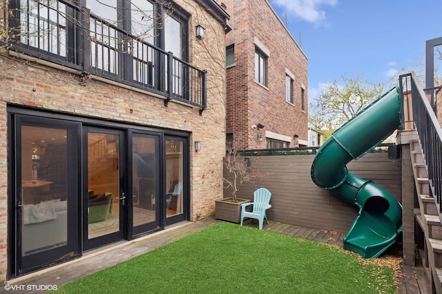 1442 W Cuyler Ave, Chicago, IL 60613 - back of property featuring a playground, brick siding, and fence