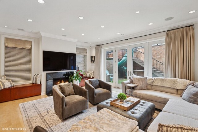 1442 W Cuyler Ave, Chicago, IL 60613 - living room with recessed lighting, light wood-style floors, a glass covered fireplace, and crown molding