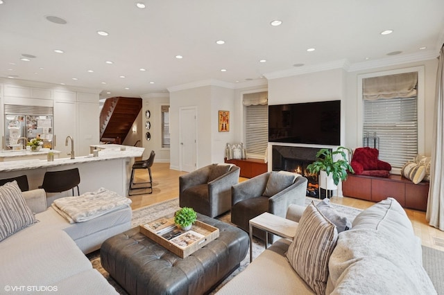 1442 W Cuyler Ave, Chicago, IL 60613 - living area featuring a lit fireplace, ornamental molding, light wood-style flooring, and recessed lighting