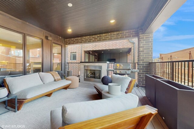 balcony with an outdoor living space with a fireplace and a grill
