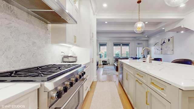 kitchen featuring appliances with stainless steel finishes, extractor fan, open floor plan, light wood-style floors, and recessed lighting