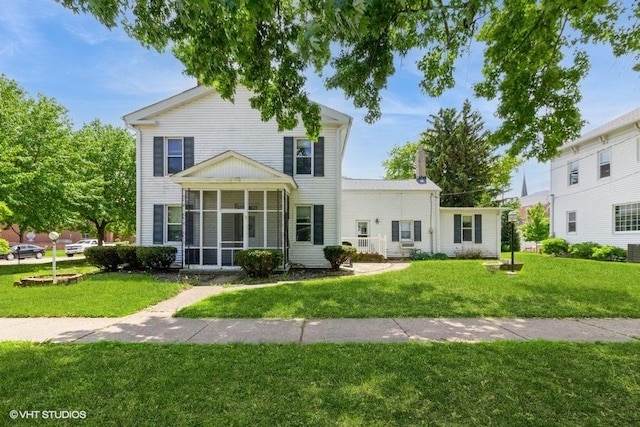 1027 Paul St, Ottawa, IL 61350 - view of front of house with a sunroom, a front yard, and central AC