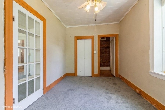 1027 Paul St, Ottawa, IL 61350 - carpeted spare room with a ceiling fan, ornamental molding, and baseboards