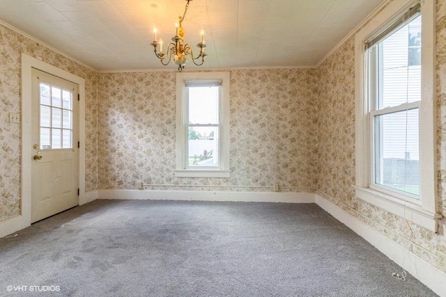 1027 Paul St, Ottawa, IL 61350 - unfurnished dining area featuring crown molding, a chandelier, carpet flooring, and baseboards