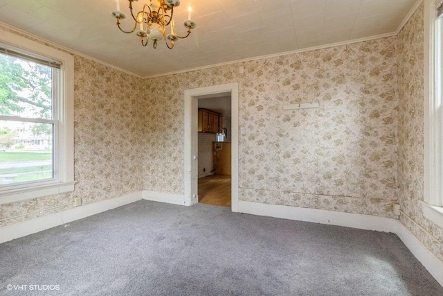 1027 Paul St, Ottawa, IL 61350 - empty room featuring a chandelier, carpet flooring, ornamental molding, and baseboards
