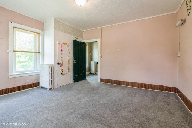 1027 Paul St, Ottawa, IL 61350 - carpeted empty room featuring radiator heating unit, ornamental molding, and baseboards