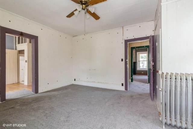 1027 Paul St, Ottawa, IL 61350 - empty room with radiator heating unit, carpet flooring, and ceiling fan