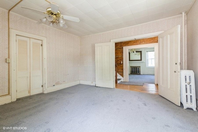 1027 Paul St, Ottawa, IL 61350 - unfurnished bedroom with carpet floors, a glass covered fireplace, crown molding, and ceiling fan