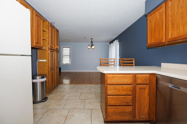 107 Regal Dr, Normal, IL 61761 - kitchen featuring freestanding refrigerator, stainless steel dishwasher, a peninsula, brown cabinetry, and light tile patterned floors