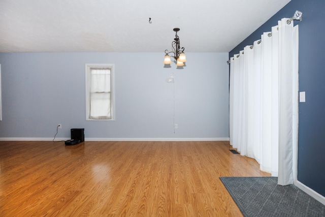 107 Regal Dr, Normal, IL 61761 - spare room featuring a chandelier and light wood finished floors