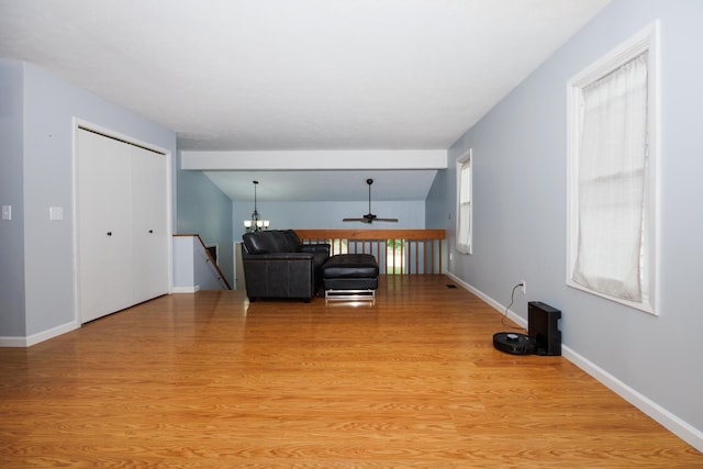 107 Regal Dr, Normal, IL 61761 - living area featuring light wood-type flooring, a ceiling fan, and a chandelier
