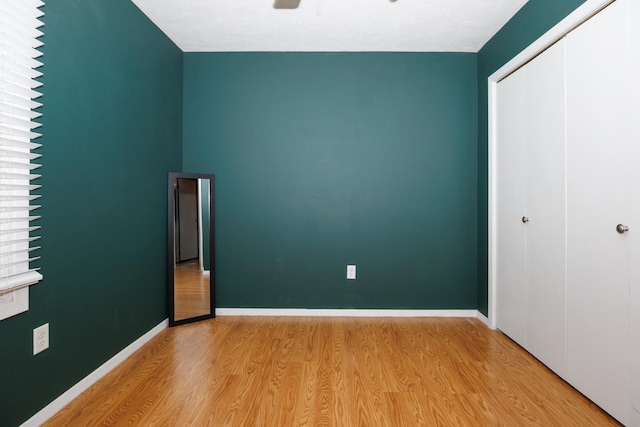 107 Regal Dr, Normal, IL 61761 - unfurnished bedroom featuring a closet, light wood-type flooring, and ceiling fan