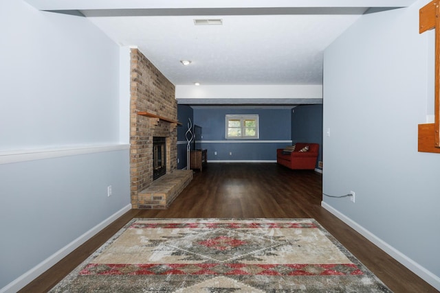 107 Regal Dr, Normal, IL 61761 - unfurnished living room with wood finished floors and a fireplace