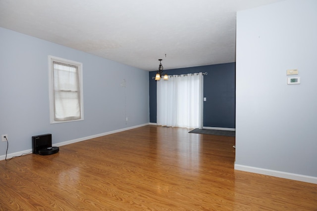 107 Regal Dr, Normal, IL 61761 - empty room featuring a chandelier and wood finished floors