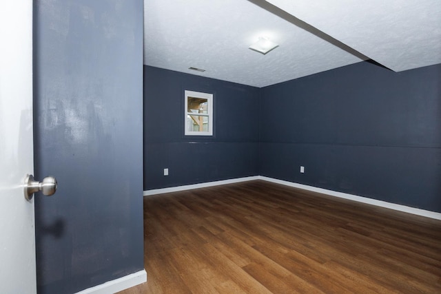 107 Regal Dr, Normal, IL 61761 - spare room with wood finished floors and a textured ceiling