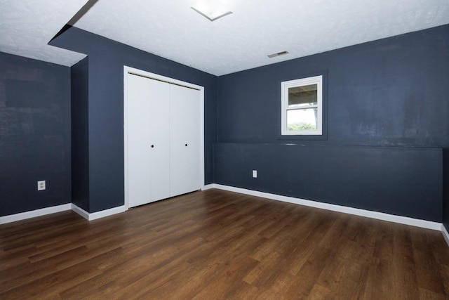 107 Regal Dr, Normal, IL 61761 - unfurnished bedroom with dark wood-style flooring and a closet