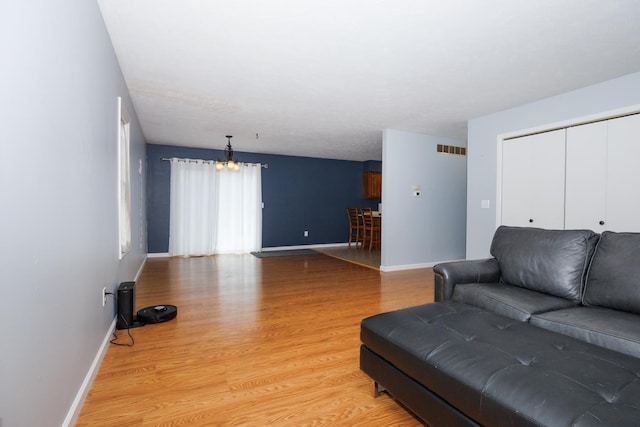 107 Regal Dr, Normal, IL 61761 - living room featuring light wood-style floors and a chandelier