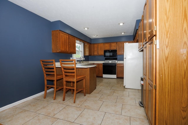 107 Regal Dr, Normal, IL 61761 - kitchen featuring white appliances, a peninsula, light countertops, brown cabinets, and light tile patterned floors