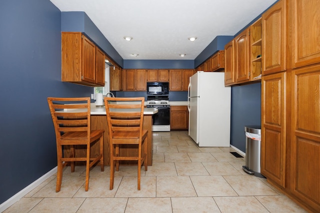107 Regal Dr, Normal, IL 61761 - kitchen with white appliances, a peninsula, light countertops, and brown cabinetry