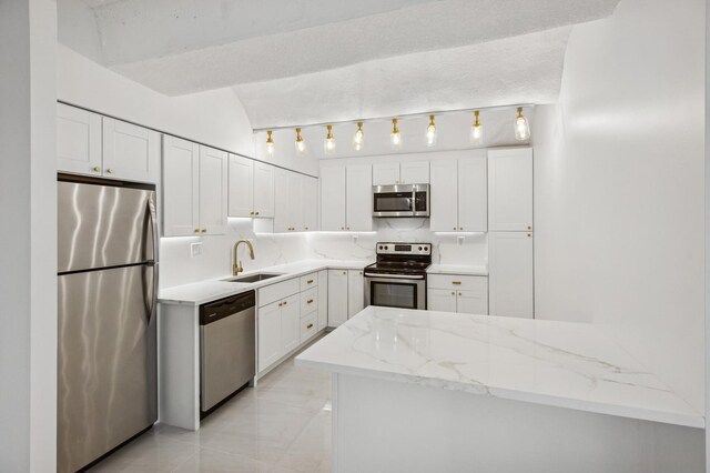 345 N Canal St Unit 1003, Chicago, IL 60606 - kitchen featuring appliances with stainless steel finishes, a sink, white cabinets, light stone counters, and tasteful backsplash