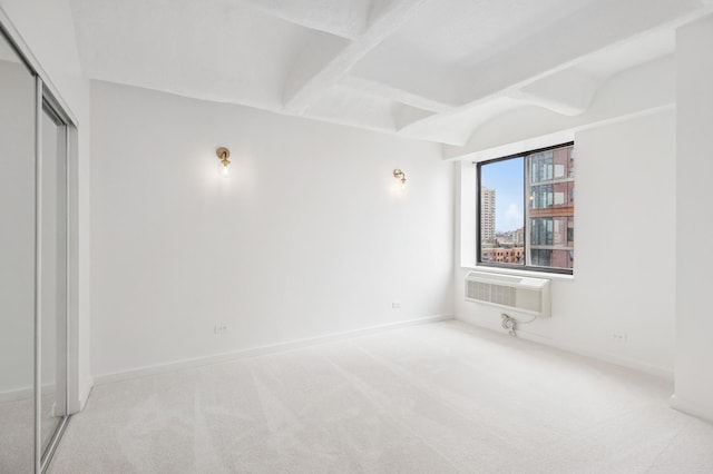 345 N Canal St Unit 1003, Chicago, IL 60606 - unfurnished bedroom featuring carpet flooring, a wall mounted AC, a closet, baseboards, and beamed ceiling