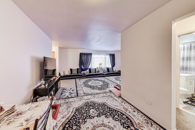carpeted living room with baseboards