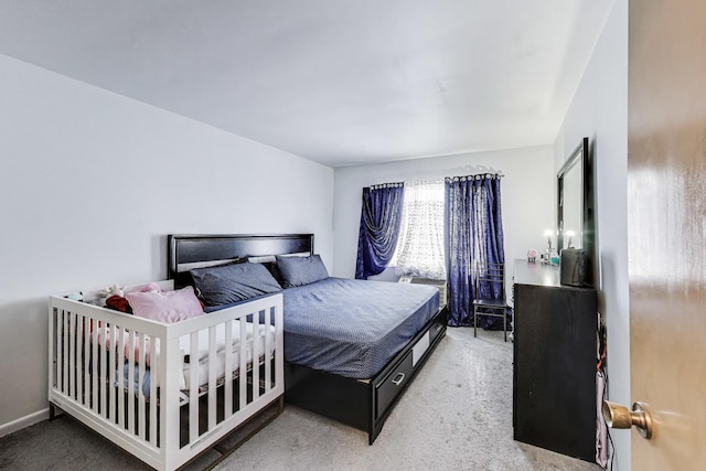 bedroom featuring light carpet
