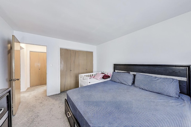 bedroom featuring light carpet and a closet
