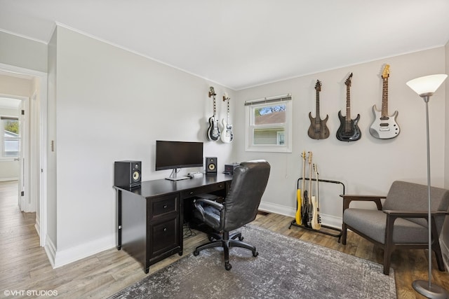 office area featuring ornamental molding, wood finished floors, and baseboards