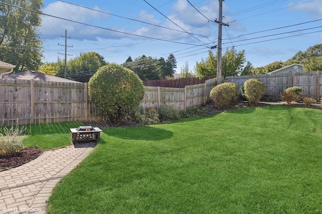 view of yard with a fire pit