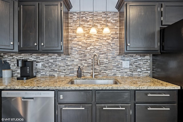 kitchen with dishwasher, a sink, tasteful backsplash, and light stone countertops