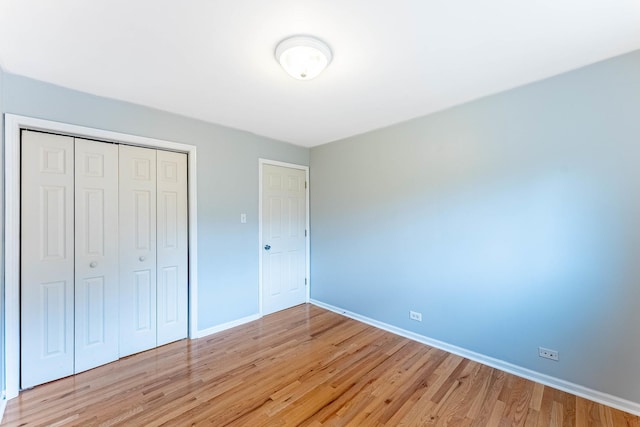 204 N Rohlwing Rd, Palatine, IL 60074 - unfurnished bedroom with baseboards, light wood-type flooring, and a closet