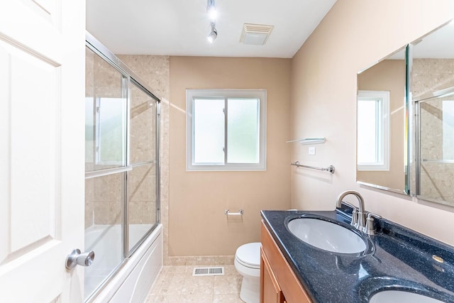 204 N Rohlwing Rd, Palatine, IL 60074 - bathroom with toilet, double vanity, tile patterned floors, shower / bath combination with glass door, and baseboards