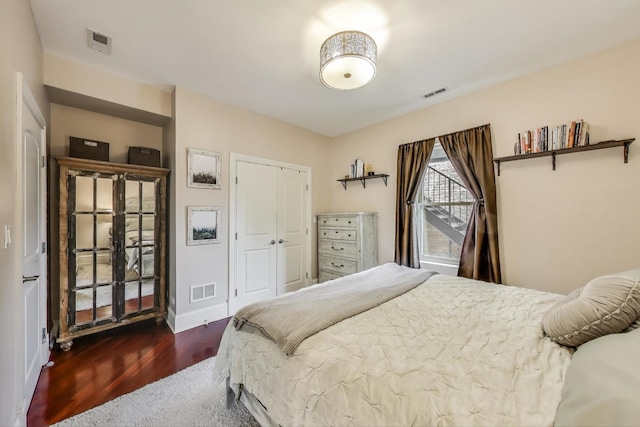 bedroom featuring wood finished floors, a closet, and baseboards