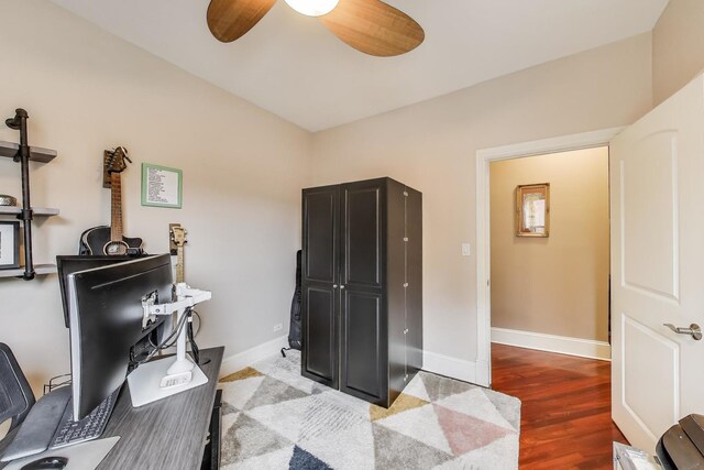 home office featuring a ceiling fan, baseboards, and wood finished floors