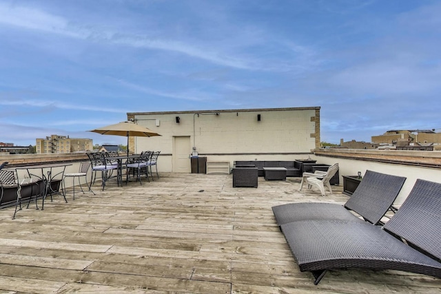 wooden terrace with an outdoor living space and outdoor dining area