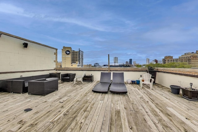 wooden deck featuring an outdoor living space and a view of skyline